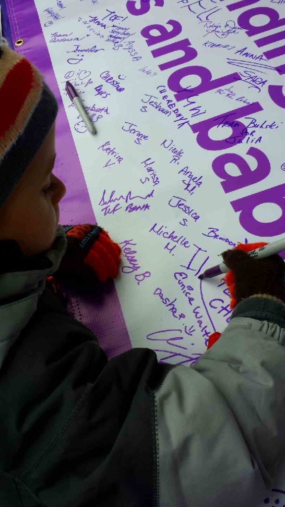 Signing the poster